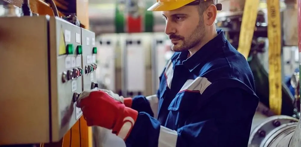 "Man inspecting the control panel of a standby generator