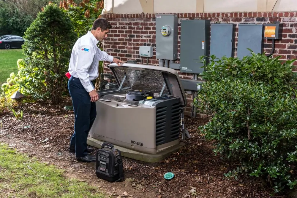 Man standing beside a malfunctioning standby generator